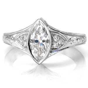 Antique inspired custom engagement ring in Akron with a unique marquise center diamond set in a bezel setting.