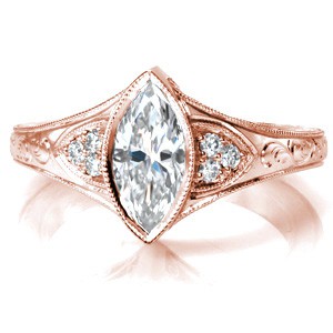 Antique inspired custom rose gold engagement ring with a unique marquise center diamond framed by bead set diamonds and hand engraving in Milwaukee.