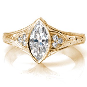 Antique inspired custom engagement ring with a unique marquise center diamond framed by bead set diamonds and hand engraving in Grand Rapids.