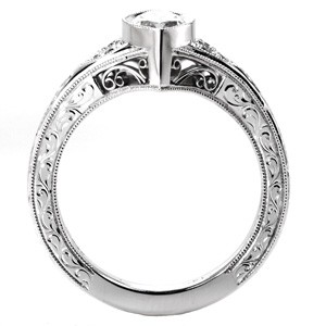 Antique inspired custom engagement ring with a unique marquise center diamond framed by bead set diamonds and hand engraving in Fargo.