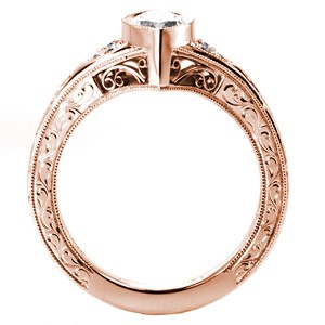Rose gold custom engagement ring in Albuquerque with a unique marquise center diamond set in a bezel setting.