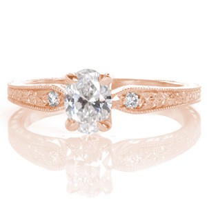 Design 3399 offers a truly feminine appeal with a petite tapering band leading to a 0.50 carat oval cut diamond. Intricate floral relief engraving embellishes the top view of the band, with wheat hand engraving featured on its profile. The band is finished with milgrain edging.