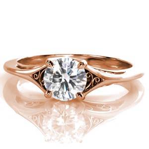 Custom filigree engagement ring in Seattle, Washington. This elegant rose gold engagement ring features a solitaire diamond center stone with hand wrought filigree adorning the top and sides of the split shank band. 