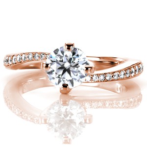 Rose gold custom engagement ring with a contemporary round cut center diamond and asymmetrical band in Montreal. 