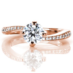 Modern rose gold engagement ring designs in Edmonton. Elegant movement highlights the center stone of this micro pave rose gold engagement ring.