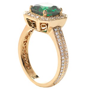 Halo engagement ring in Columbus with emerald center stone, filigree and double row diamond band.
