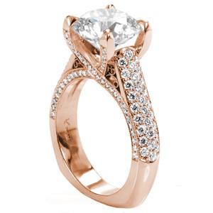 Rose gold engagement ring in Fargo with micro pave diamonds, round center stone and hand formed filigree.