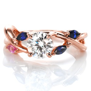 Graceful curves of two bands of gold are woven to create the captivating look of the Diane design.  Crafted in 14k yellow gold and shown with a round cut center diamond of 1.00 carats.  The split band has four marquise cut sapphires placed perfectly into the woven band openings.