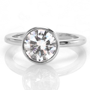 A 1.30 carat round brilliant cut diamond draws all the attention in this modern ring setting. Design 3424 features an elegant rounded central bezel setting that tapers as it reaches the finger. A petite high polished rounded band completes the look of this effortless design. 