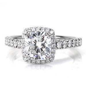 Design 3425 is an elegant combination of a classic halo outline paired with a unique filigree cathedral. A prong set 1.50 carat cushion cut diamond rest at its center with a regal appeal. Bezel set marquise shaped surprise stones add the finishing touch to this extraordinary ring design.