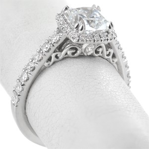Custom engagement ring with cushion center stone, filigree and diamond halo in Ottawa.
