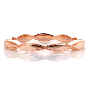Design 3426 is an elegant alternative to a traditional diamond wedding band. The petite elongated repeating marquise shapes could add interest against any custom engagement ring. The eternity span band features a high polished finish with hand applied milgrain edging.