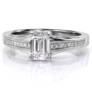 Design 3428 is a breathtaking vintage inspired setting worthy to frame the beautiful 0.80 carat emerald cut diamond at its center. The profile of the ring displays an intricate labyrinth of hand formed filigree curls, with beadset diamonds and milgrain edging run a half span atop the flaring band. 