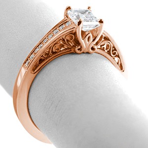 Custom rose gold engagement rings in St. Louis with hand formed filigree curls and a diamond band.