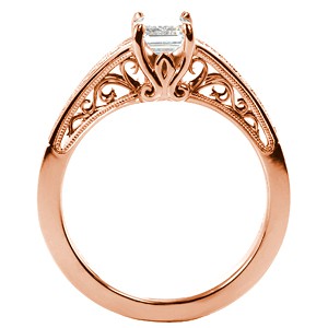 Rose gold engagement ring in Fargo with filigree and emerald cut center stone.