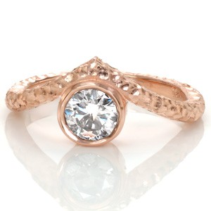 Unique, one of a kind rose gold engagement rings in Atlanta. Create your own perfect custom design, such as this bezel set rose gold stacker ring. This unique engagement ring features a hammered finish with an angled band around a round bezel set center diamond.