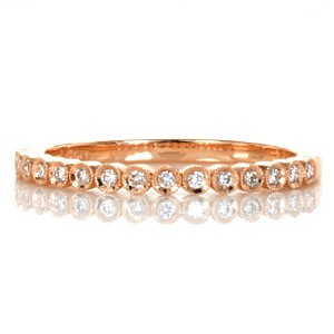 Cute rose gold stacking ring in Salt Lake City is the perfect addition to a set of stackers! This stackable rose gold ring design is made of individually bezel set round diamonds, with milgrain detailing the bezels.