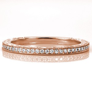 Design 3439 is a step above the traditional diamond wedding band. The top is adorned with brilliant bead-set diamonds and the sides feature unique relief style hand engraving. These intricately hand engraved scroll patterns stand out against the stippled background. Milgrain textured edges create a cohesive final look.
