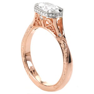 Unique rose gold engagement ring with a custom halo in Kansas City. This split shank engagement ring is a two-tone rose gold design. The band is elegantly detailed with hand engraving and filigree curls for vintage appeal.