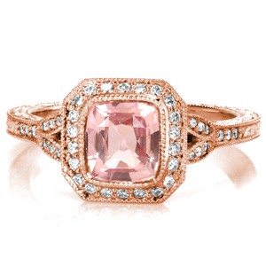Custom split shank rose gold engagement ring in Atlanta. A unique radiant halo around a pink cushion cut sapphire center stone are the perfect focal point for the rose gold's warm hues.