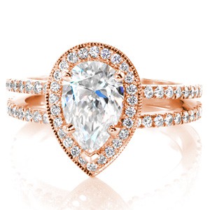 Rose gold engagement ring in Cleveland with pear shape center stone, split shank and diamond halo.