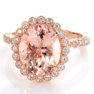 Design 3455 is an effervescently modern take on a halo engagement ring design. The diamond halo, basket, and band are all formed of small round brilliant diamonds in tiny bezel settings with milgrain. The 3.20 carat oval morganite center stone is a perfect color compliment to the warm peachy pink hue of the rose gold. 
