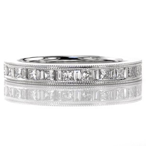 Design 3458 is a stylish band with the luster of 14k white gold and diamonds. The alternating princess and baguette stones create a captivating effect with the brilliant and step cuts. A double row of milgrain frame the diamonds adding texture and depth to the edges of the band.  