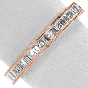 Calgary, Alberta unique rose gold stacking bands. This beautiful rose gold wedding band is a channel setting with alternating princess cut and baguette diamonds. A double row of milgrain frames the gems on this stacking ring.