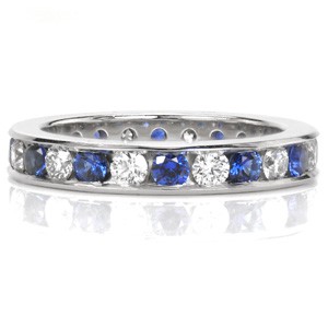 Design 3461 is mesmerizing with the sequence of natural blue sapphires and sparkling white diamonds in a continuous pattern. The sleek channel setting securely fashions each stone in an eternity span. A high polish finish is applied to the surface of the ring. 
