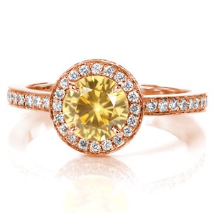 Design 3470 is a contemporary piece which features a beaming 1.20 carat round cut yellow sapphire center stone in a 14k white gold setting. The crisp lines of the halo are matched with bead set round cut diamonds on the halo apron for a finished presentation.