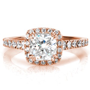 A rose gold halo engagement ring made around a cushion cut diamond is a perfect combination! The hand formed filigree curls that decorate the sides underneath the halo are truly spectacular!