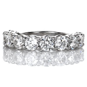 Design 3483 is a perfect statement band with .25 carat brilliant cut round diamonds forming a dazzling arc. This regal design features elegant, scalloped shared-prong settings. Great as a wedding band, anniversary piece, or part of a show stopping stacking-set.  