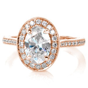 Design 3484 is an elegant tribute to vintage ring designs. The oval center stone is surrounded by a diamond halo, and set low to the finger. A micro pavé diamond band features hand engraved scroll patterns, while the under-halo basket is filled with intricate, hand-formed filigree curls.
