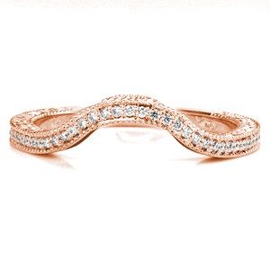 This elegant wedding band contours around the gentle curves of Design 3499. Micro pavé diamonds match the stone distance of the engagement ring, making this a perfect set. Relief hand engraving, filigree and a surprise blue sapphire are mirrored on the side face of the wedding band for a complete look.  