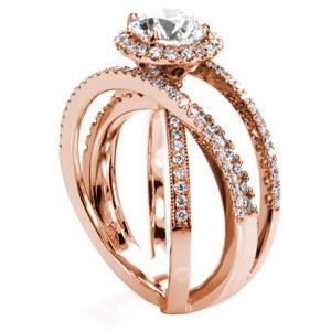 Rose gold wedding ring in Colorado Springs with diamond halo, round center stone and overlapping diamond bands.
