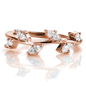 Rose gold stacker ring is a stunning wedding band possibility in Providence. This stacking ring is featured in rose gold with marquise diamonds looking like leaves on a vine ring.
