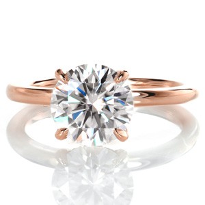 An elegant statement is made by Design 3509. This custom engagement ring pairs a sparkling 2.00 carat moissanite center stone with a petite rounded band. The center stone is held in a four prong basket setting with the delicate addition of accent micro pavé diamonds. 