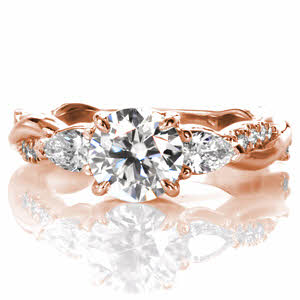An interwoven masterpiece, Design 3511 features a 1.20 carat round brilliant center diamond bordered on either side by a pear cut side diamond. Twisted bands, one high polished and one prong diamond set, extend the length of the ring. On the profile view the three stone trellis detailing can be seen.