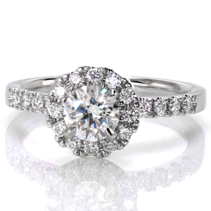 A classic engagement ring style, Design 3535 is a bright halo design created for a 0.33 carat round brilliant center stone. This elevated center halo leaves room for a straight wedding band to sit flush next to the band. Prong settings match the diamonds on the band to the halo.