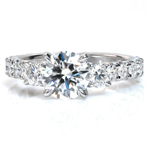 Design 3542 is a regal design featuring a French, hand cut pavé style known as U-Cuts on the band. The three center stones are raised up to allow for a flush fit against a straight wedding band next to the decorative baskets of the center settings.