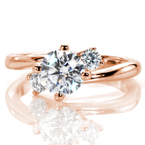 Design 3545 is an elegant contemporary three-stone design. The smooth, flowing lines of the tapered band highlight the center trio as the high polished luster of the metal contrasts with the dazzling sparkle from the diamonds. The prongs of each setting grow from the band for an organic inspired crown.  