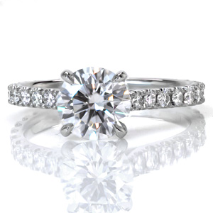 Design 3551 is a perfect example of classic beauty. The cathedral band is set with U-cut micro pavé diamonds. A delicate ring of small diamonds is set in between the prongs of the center setting, adding brilliant flashes of color from all sides.