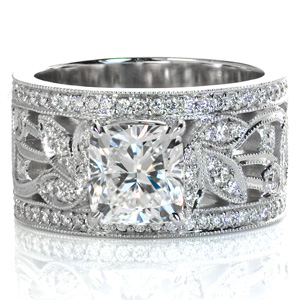 Design 3552 is a detailed organic design featuring beautiful  micro pavé leaves and vines flowing down the sides of the band. This wide band design is shown with a Euro-shank base, and is shown with a cushion cut center stone. The edges of the pattern are all detailed with a beaded milgrain texture.