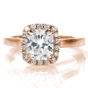 This regal cathedral setting features a custom high polished band crowned with a dazzling V-cut micro pavé halo. The cushion cut center stone is held in place with pairs of claw prongs. Perfectly designed to wear with a wedding band, Design 3554 is the epitome of classic beauty.  