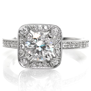 Design 3559 has a stunning, antique inspired halo framing a 0.70 carat round cut center stone set within four double prongs. The halo features softer, rounded corners and half moon contour elements. The halo is slightly uplifted over the diamond set band to allow a perfect match for a future wedding band.