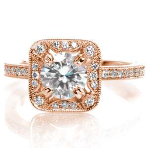 Design 3559 has a stunning, antique inspired halo framing a 0.70 carat round cut center stone set within four double prongs. The halo features softer, rounded corners and half moon contour elements. The halo is slightly uplifted over the diamond set band to allow a perfect match for a future wedding band.