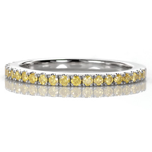 Yellow diamonds add a vibrant, colorful detail to this classic wedding or anniversary band. The U-cut micro pavé setting style keeps each gem held securely while allowing for the maximum amount of visibility and sparkle. The high polished metal of the band adds a beautiful shine to the already dazzling band.