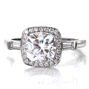 Design 3587 is a unique three stone design featuring tapered baguette diamond side stones in half bezel settings framing a micro pavé cushion halo. The side view reveals an elegant woven trellis pattern customized to allow for a non-contoured wedding band. 