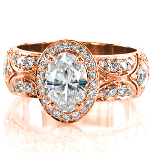 A stunning mix of antique inspired star burst patterns, and a contemporary width; this oval diamond halo is simply regal. The micro pavé halo and band are framed with delicate high polished rails. The top of the band is gently domed for a more elegant curve.