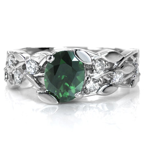 Design 3605 features a beautiful green sapphire center stone that is perfect for a nature themed piece. This leaf and vine pattern is set with round brilliant cut diamonds for a hint of sparkle. The center stone is incorporated into the design with the use of leaf shaped prongs.